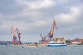 Shipyard with cranes and tourist boats in Gothenburg Royalty Free Stock Photo