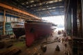 shipyard, with view of workers putting finishing touches on a newly constructed vessel