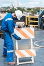 Shipyard worker with protective mask working on a sunny day