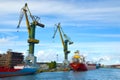 Shipyards and docks with cranes and other heavy machinery near in industrial part of old town Gdansk, Baltic coast, Gdansk bay, Po Royalty Free Stock Photo