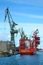 Shipyards and docks with cranes and other heavy machinery near in industrial part of old town Gdansk, Baltic coast, Gdansk bay, Po Royalty Free Stock Photo