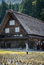 Shirakawa, Gifu, Japan - October 2022 - Unidentified Japanese farmer with a background of Shirakawago village during autumn with a