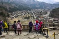 SHIRAKAWA, JAPAN- MARCH 27, 2019: Tourists on the viewing platform take a selfie on the background of a panoramic view of