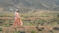 Beautiful Qashqai nomadic woman walking in meadow, Shiraz, Iran