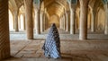 Unidentified woman walking in prayer hall of Vakil Mosque with columns, Shiraz, Iran