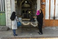 Iranian women near a street bakery. People buy traditional Iranian pita bread