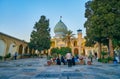 SHIRAZ, IRAN - OCTOBER 12, 2017: The visitors of Imamzadeh Ali Ibn Hamzeh Holy Shrine relax at its scenic garden, located in