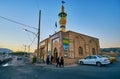 SHIRAZ, IRAN - OCTOBER 12, 2017: The visitors at the small mosque with shiny gold minaret, located at the busy Pishro street, on
