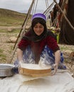 Shiraz, Iran - 2019-04-09 - Qashgal woman makes bread from home ground flour Royalty Free Stock Photo