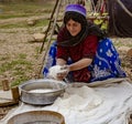 Shiraz, Iran - 2019-04-09 - Qashgal woman makes bread from home ground flour