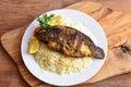 Shiri Fish fry with White Rice, tomato and lime served in dish isolated on wooden table top view middle eastern lunch food