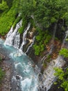 Shirogane waterfall in Shirogane onsen in Biei, Hokkaido, northern Japan blue, with turquoise water of pond caused by colloidal a