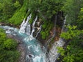 Shirogane waterfall in Shirogane onsen in Biei, Hokkaido, northern Japan blue, with turquoise water of pond caused by colloidal a