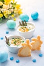 Shirred eggs Oeuf cocotte or baked eggs with green asparagus with Easter bunny and eggs Royalty Free Stock Photo