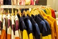 Shirt and pant hanging on hangers on a clothing rack and arranged in shelf in a modern clothe store Royalty Free Stock Photo