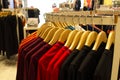 Shirt and pant hanging on hangers on a clothing rack and arranged in shelf in a modern clothe store Royalty Free Stock Photo