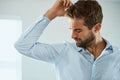 Shirt, stress with man smelling armpit sweat stain and indoors at his home. Hygiene or hyperhidrosis, deodorant Royalty Free Stock Photo