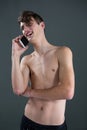 Shirtless androgynous man talking on mobile phone Royalty Free Stock Photo