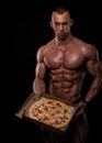 Shirtless athlete with pizza Royalty Free Stock Photo