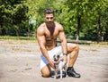 Shirtless Athletic Man with Dog in his Arms