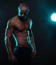 Shirtless Athletic Man Looking Down with Spotlight