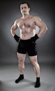 Shirtless athletic muscular man standing akimbo Royalty Free Stock Photo