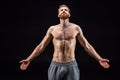 Shirtless bearded bodybuilder posing isolated on black