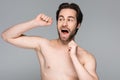 shirtless and bearded man flossing teeth Royalty Free Stock Photo