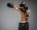 Shirtless brutal boxing fighter in virtual reality glasses.