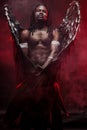 Shirtless dark angel in red smoky space Royalty Free Stock Photo