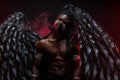 Shirtless dark angel in red smoky space Royalty Free Stock Photo