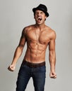 Shirtless frustration. A shirtless young man wearing a hat and screaming with his eyes closed. Royalty Free Stock Photo