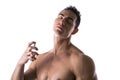 Shirtless male model spraying cologne Royalty Free Stock Photo