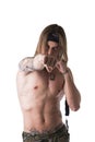 Shirtless male model throwing punch towards camera