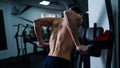 Shirtless man doing triceps dips from parallel bars in gym. Royalty Free Stock Photo