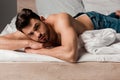 Shirtless man in jeans lying on Royalty Free Stock Photo