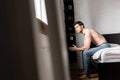 Shirtless man in jeans sitting on Royalty Free Stock Photo