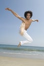 Shirtless Man Jumping On Beach Royalty Free Stock Photo