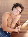Shirtless man, portrait and happpy guy in jeans laying down on wood floor with happy and sexy smile. Attractive, healthy Royalty Free Stock Photo