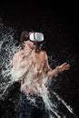 shirtless man in vr headset swilled with water