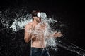 shirtless man in vr headset swilled with water