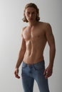 Shirtless, model and portrait of man in jeans on studio, white background and mockup with fashion. Male, beauty and Royalty Free Stock Photo