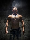 Shirtless Muscle Man Looking Up Into Bright Overhead Light