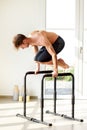 Man doing planche exercise on high bars