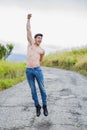 Shirtless muscular young man jumping for joy Royalty Free Stock Photo