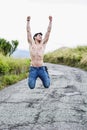 Shirtless muscular young man jumping for joy Royalty Free Stock Photo