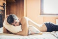 Shirtless male model lying alone on his bed