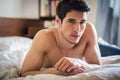 Shirtless male model lying alone on his bed Royalty Free Stock Photo