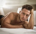 Shirtless sexy male model lying alone on his bed Royalty Free Stock Photo