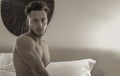 Shirtless sexy male model lying alone on his bed Royalty Free Stock Photo